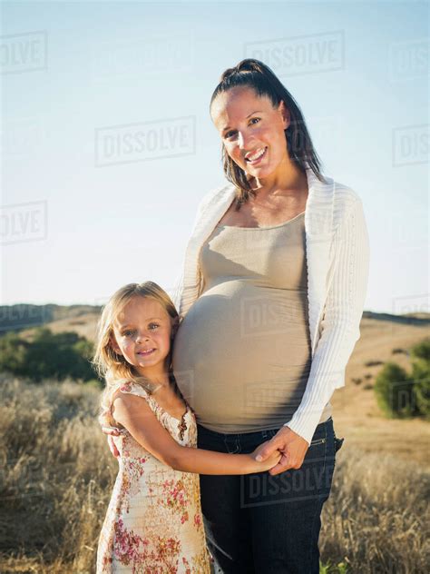 Pregnant Mother And Daughter In Rural Field Stock Photo Dissolve