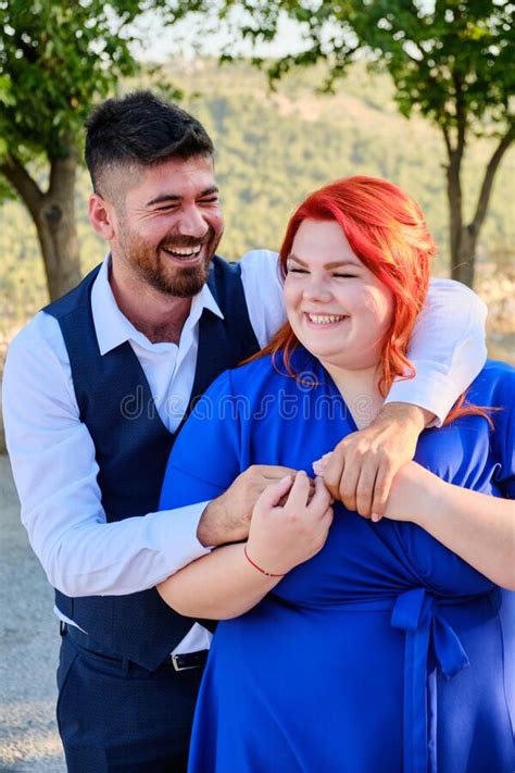 Woman Hugs Her Beloved Man Looking To A Camera Stock Photo Image Of