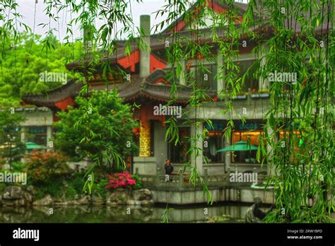 Capture the serene charm of a river winding through traditional houses