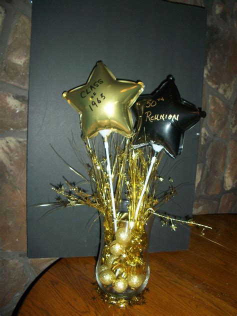 A Vase Filled With Gold And Black Balloons