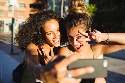 female friends taking a selfie by stocksy contributor michela ravasio stocksy