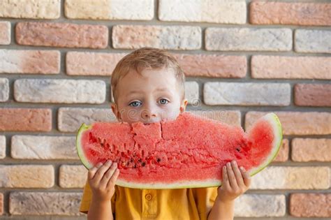 Funny Kid Eating Watermelon Indoors Focus On Eyes Stock Image Image