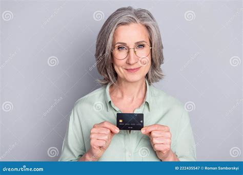 Photo Of Happy Lovely Charming Granny In Glasses Show Hold Credit Card