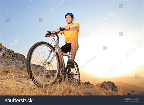 Person Riding A Mountain Bike On A Sunset Low Angle View Stock Photo