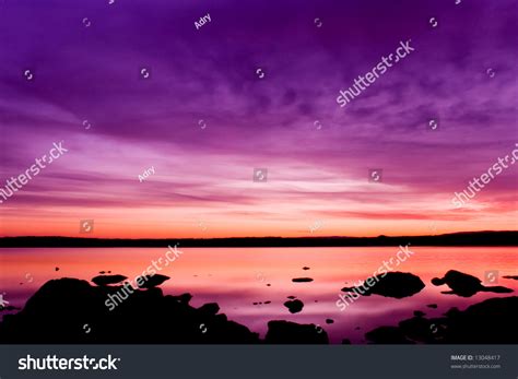 Idyllically Purple Sunset Over Sea Water Stock Photo