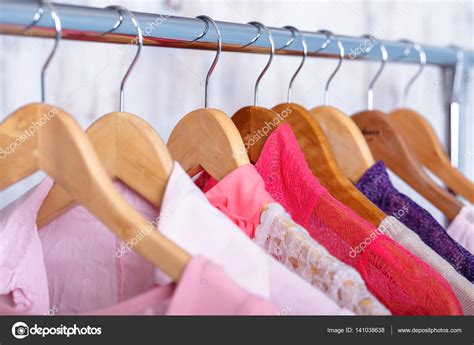 Pink Womens Clothes On Hangers On Rack In Fashion Store Closet Stock