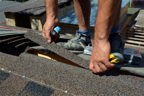 Repair Of A Roofing From Shingles Roofer Cutting Roofing Felt Or Bitumen During Waterproofing