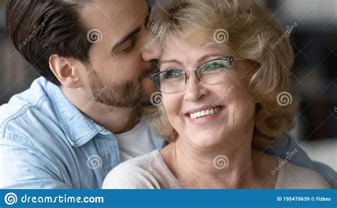 Close Up Adult Son Kissing Beautiful Mature Mother Wearing Glasses