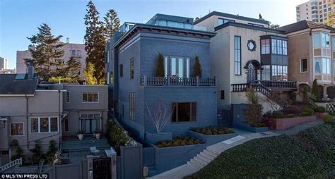 An Apartment Building With Several Balconies On The Top Floor And