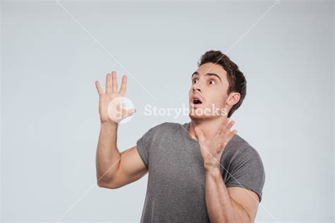 Startled Young Man Expressing Surprise And Shouting Isolated On White