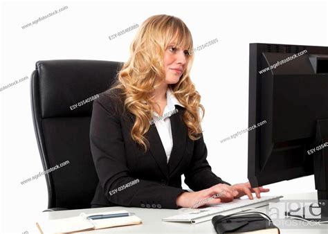 Beautiful Secretary In A Stylish Black Suit Sitting Typing At Her Desk