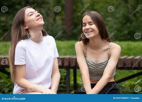 Laughter And Fun In Summer Young Women Laughing In The Park Happy Friends Relaxing In Nature