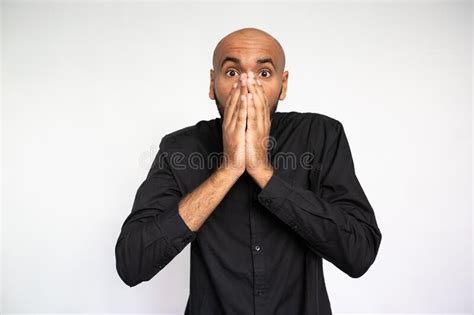 Portrait Of Shocked Young Man Covering Mouth With Hand Stock Image