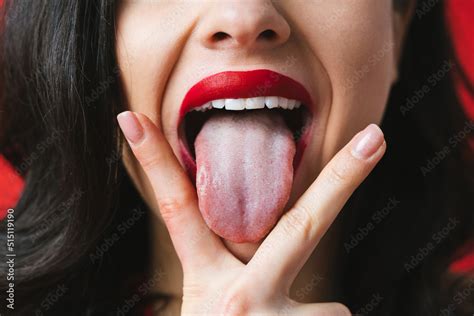 Image Of A Woman Sticking Her Tongue Out Between The Fingers Stock