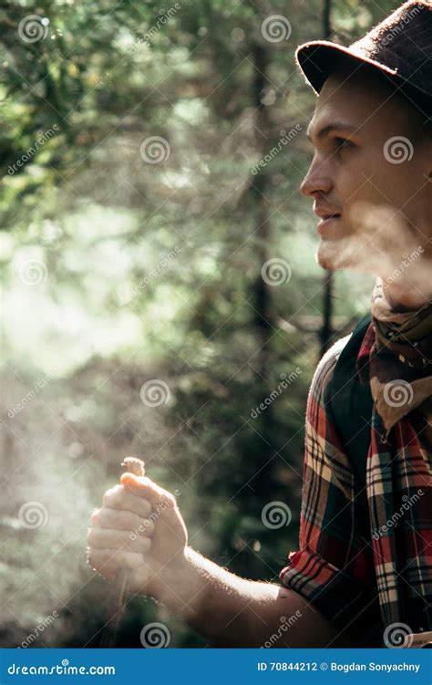 Stylish Hipster Traveler Exploring In Sunny Forest In The Mountains