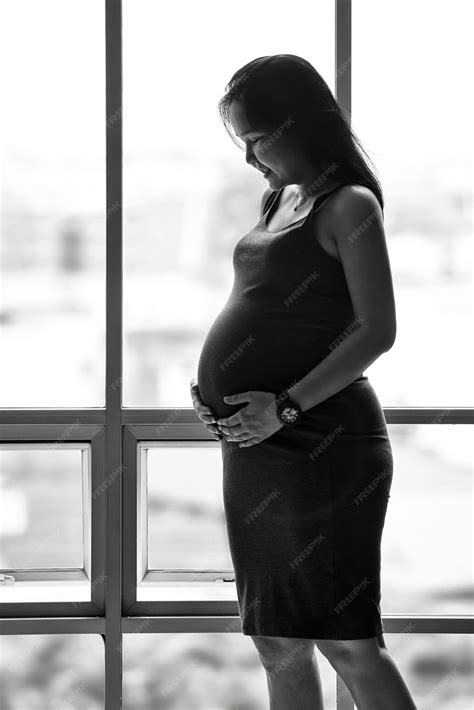 Premium Photo Close Up Of Happy Pregnant Asian Woman With Big Belly At Window
