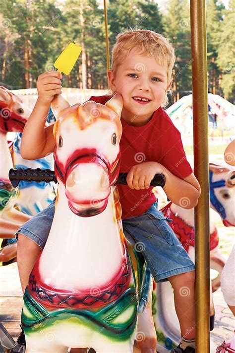 Curly Little Boy Riding A Carousel Stock Image Image Of Faces Laugh
