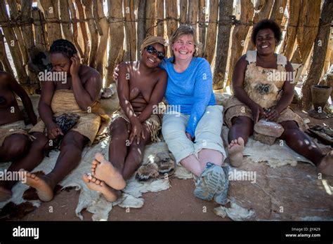 Damara Woman And Tourist Pose And Smile For A Photograph At The Damara Living Museum Located In