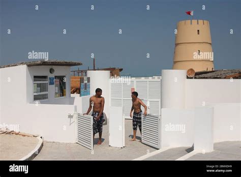 Two Young Men At The Entrance To Al Dar Island Beach Resort With The