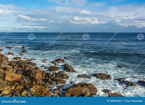 Seashore With Rocks Wavesdeep Blue Waters Blue Skies With Whi Stock