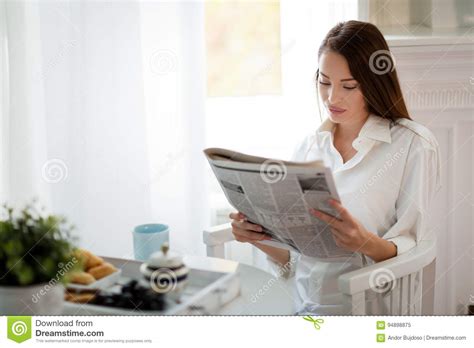 Young Beautiful Woman Reading Magazine At Table Stock Image Image Of