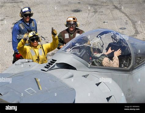 Us Navy Flight Deck Crewmen Use Hand Signals To Communicate With The
