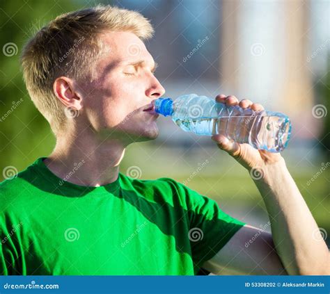 Tired Man Drinking Water From A Plastic Bottle Stock Photo Image Of