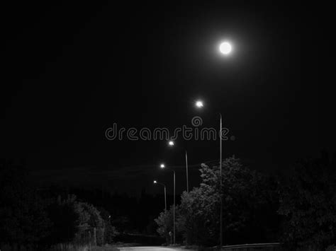 A Line Of Night Lights And The Full Moon Stock Image Image Of