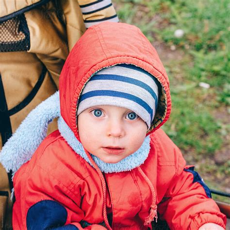 Little Boy Sitting In Baby Carriage Outdoors Looking At Camera Del