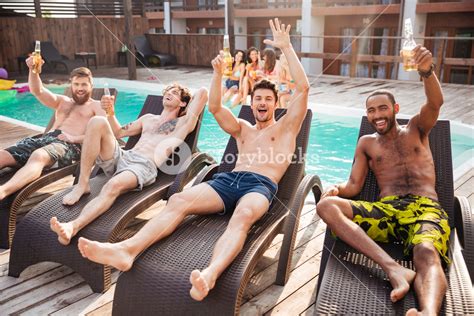 Handsome Young Smiling Men Having Fun In Swimming Pool And Drinking Beer Royalty Free Stock