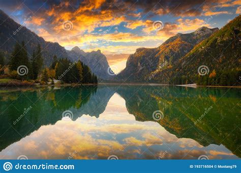 Dolomites Mountains With Reflection In Lago Di Dobbiaca Lake At Sunrise
