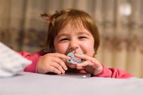 A Little Girl With A Pacifier Posing In Her Room Stock Photo Image Of