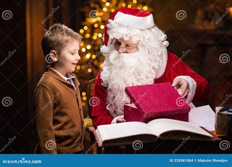 Santa Claus And Little Boy Cheerful Santa Is Working While Sitting At