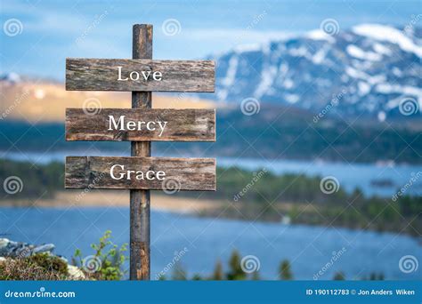 Love Mercy And Grace Text On Wooden Signpost Stock Image Image Of