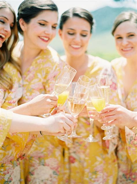 bride and her bridesmaids in yellow pretty plum sugar floral robes wedding sets dinner party