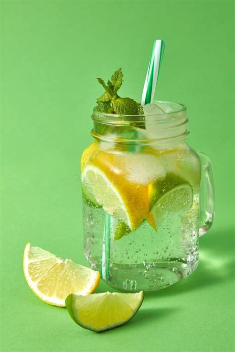 Homemade Sparkling Lemonade With Ice Slices Of Lime And Lemon Leaf Of