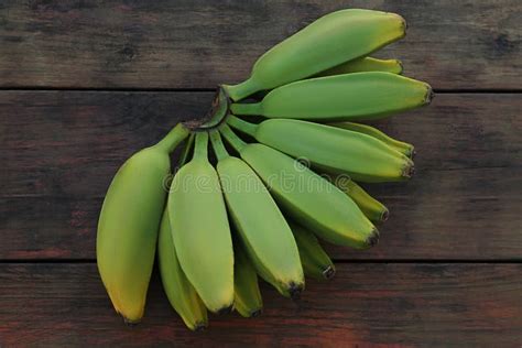 Bunch Of Delicious Bananas On Wooden Table Top View Stock Photo