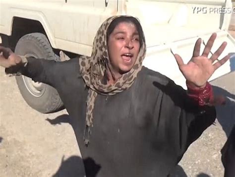 isis woman tears burqa to show leopard print shawl in defiant act video
