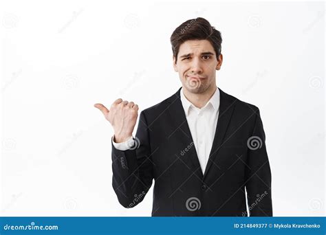 Disappointed Business Man Frowning Pointing Left At Bad Work