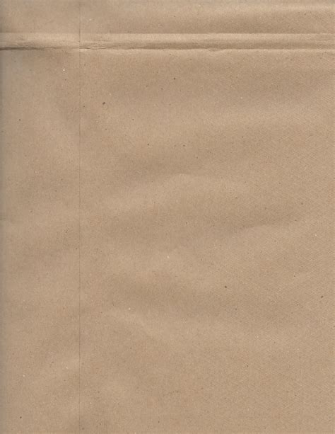 An Open Brown Paper Bag With A Piece Of Food In Its Bottom Corner