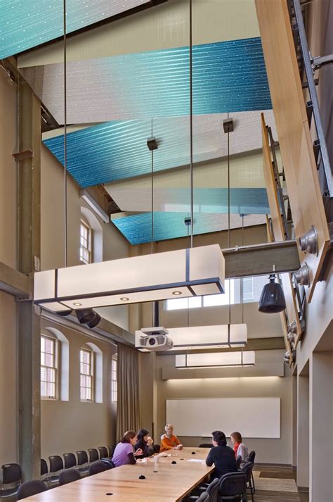 Sparkling Aqua Metal Canopies Brighten This Conference Room