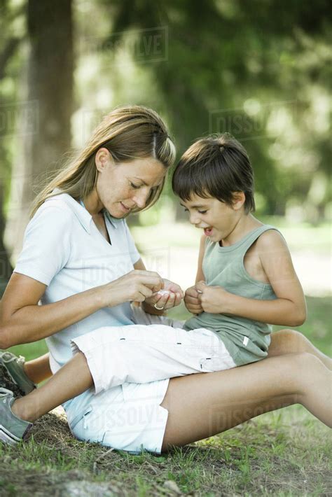 Mother And Son Sitting Outdoors Playing Together Stock Photo Dissolve