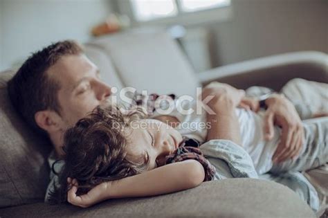 Close Up Of A Father And Son Having A Nap Together Bed Wetting Caregiver Medical Problems