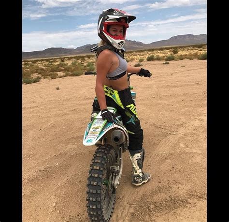 A Woman On A Dirt Bike In The Desert