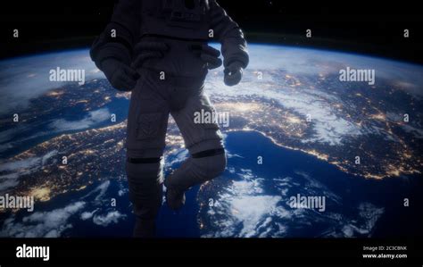 Astronaut In Outer Space Against The Backdrop Of The Planet Earth Stock
