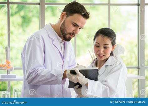 Two Medical Doctors Consulting With Paper At The Hospital Stock Photo