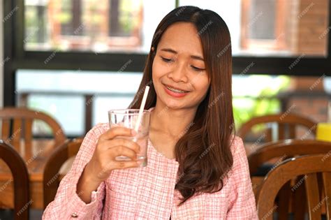 premium photo asian woman drinking water in glass