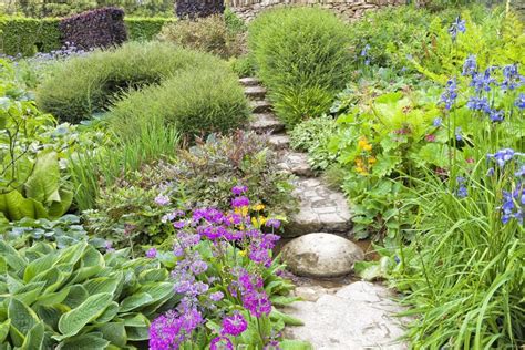 Traditional English Garden With Stone Steps Going Up Through Colorful