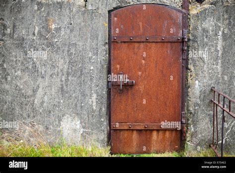 Rusted Metal Door In Old Fortification Wall Background Texture Stock