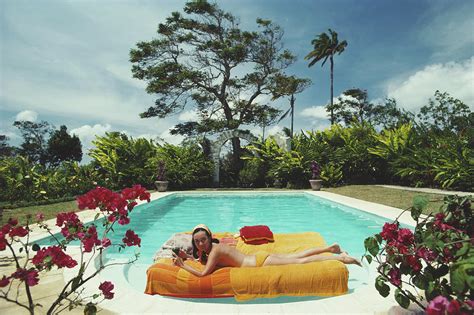 Sunbathing In Barbados Photograph By Slim Aarons Pixels